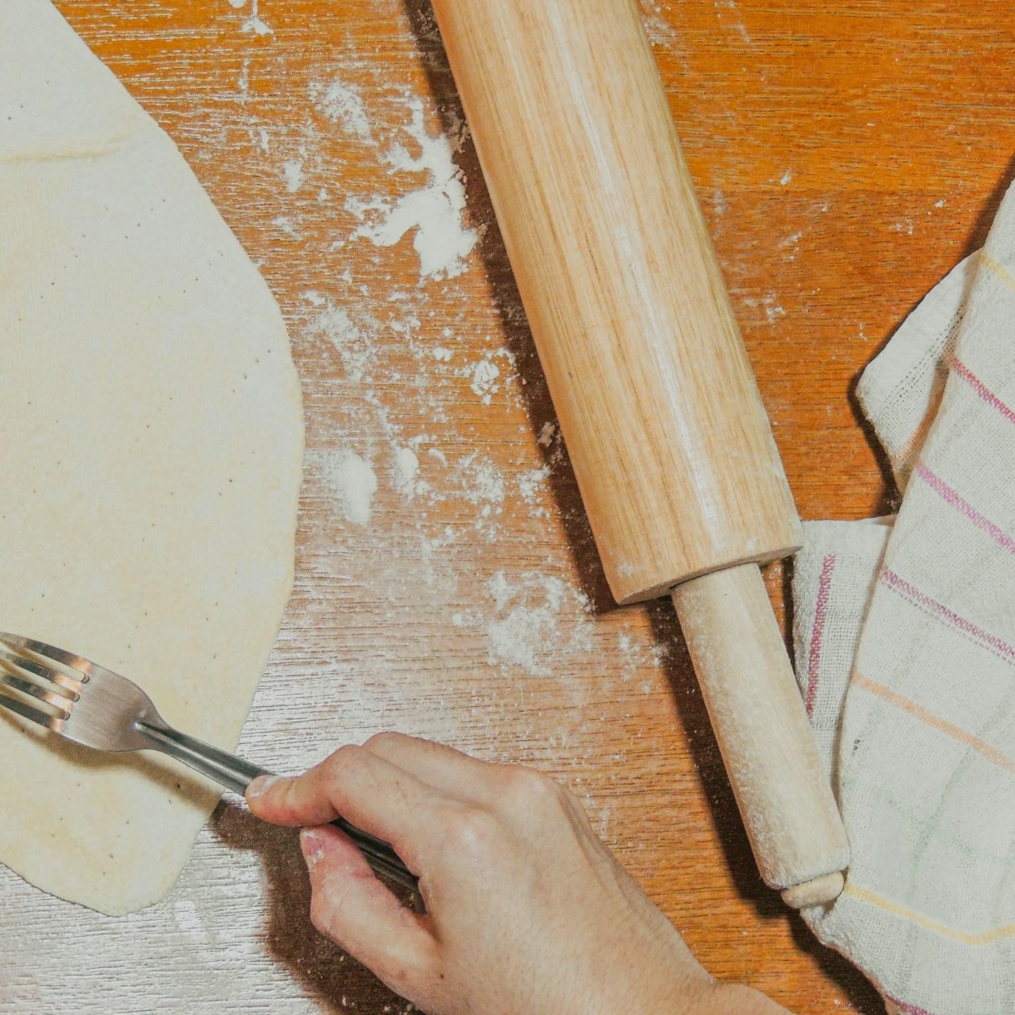 Diverse group of community members sharing a meal, highlighting the social bonds formed through collaborative cooking